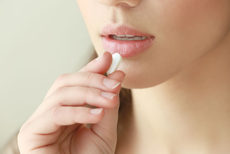 dental patient taking sedation pill