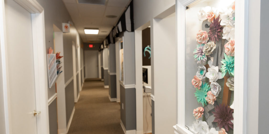 Smile! Dental Center - Jarrett Foust, DDS Hallway with beautiful floral decor