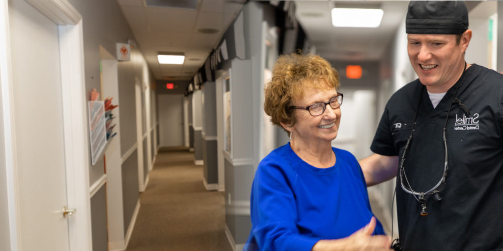 Margaret with Dr. Foust in the hallway smiling and chatting