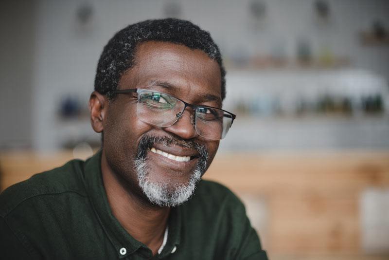 Mature black man smiling in the coffee shop